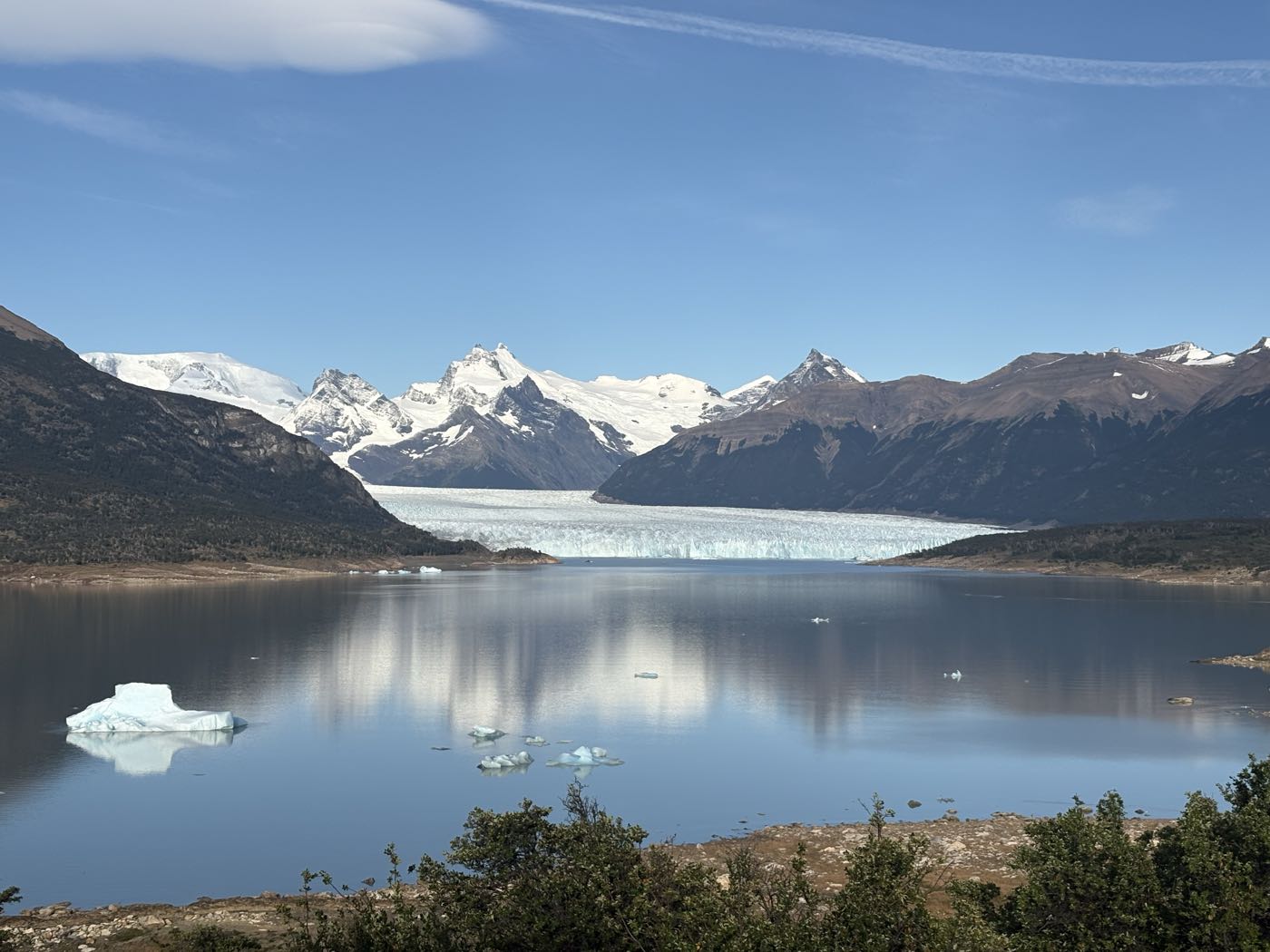 The Perito Moreno glacier across the lake, with an iceberg in the foreground